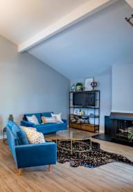 a living room and dining room with a table and chairs