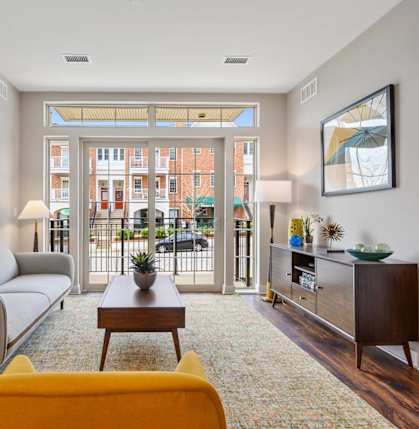 a living room with a couch and a coffee table and a balcony