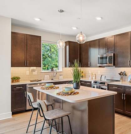a kitchen with stainless steel appliances and wooden cabinets