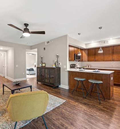 A modern kitchen with a wooden island and stainless steel appliances.