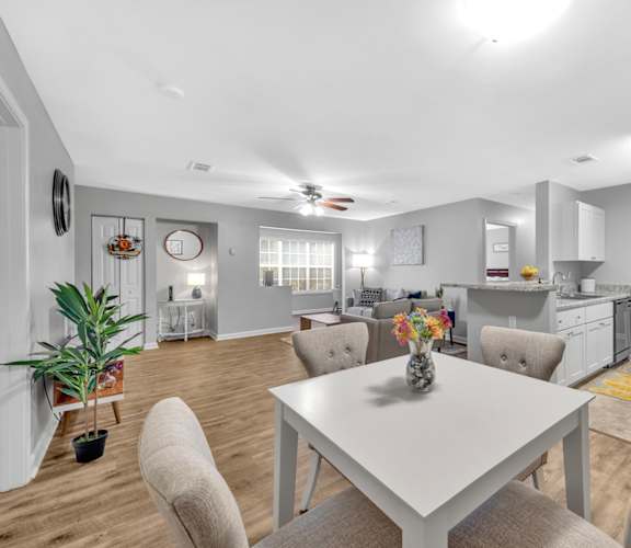A modern kitchen with a dining table and chairs.
