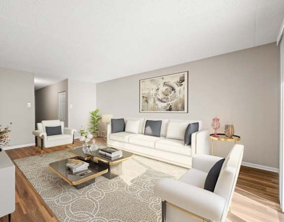 A living room with a white sofa, a coffee table, and a painting on the wall.