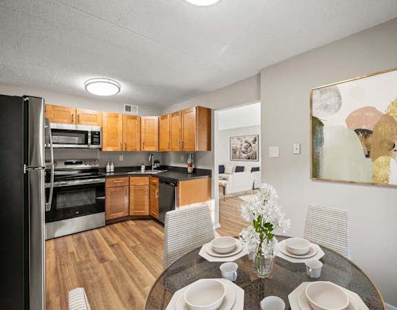 A modern kitchen with a dining table set for four.
