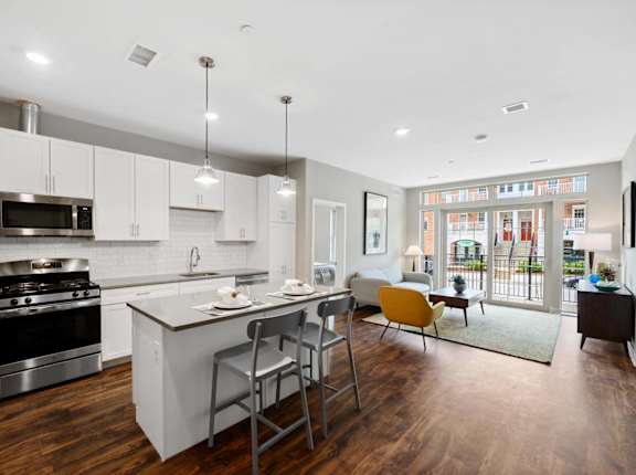 an open kitchen and living room with a table and chairs