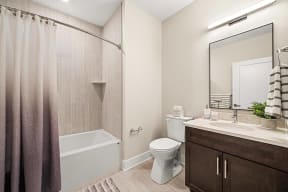 a bathroom with a shower toilet sink and mirror