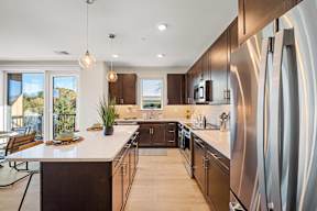 a large kitchen with wooden cabinets and stainless steel appliances