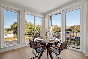 Dining areas in Hamilton Passive House offer floor to ceiling windows that open up to a balcony