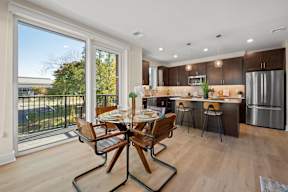 a kitchen and dining room with a table and chairs