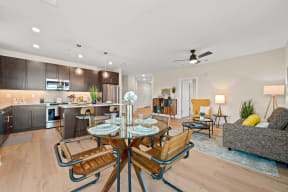a living room and kitchen with a table and chairs