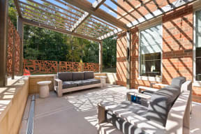a covered patio with furniture and a glass roof