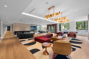 a large lobby with couches and chairs and a large table with chairs