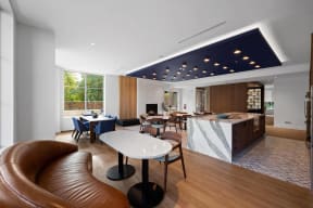 a hotel lobby with a table and chairs and a kitchen