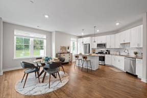 an open kitchen and dining area with a table and chairs