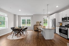 a kitchen with an island and a table with chairs