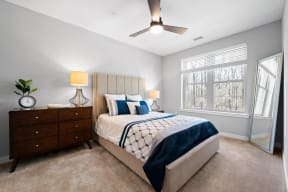 a bedroom with a bed and a ceiling fan