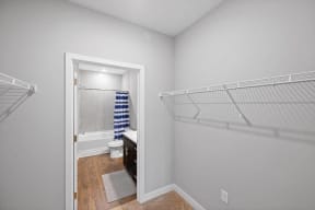 a bedroom with a bathroom and a closet