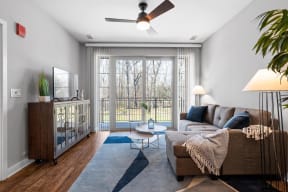 a living room with a couch and a ceiling fan
