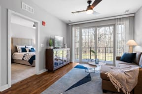 a living room with a couch and a ceiling fan