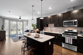 a large kitchen with a center island and a living room