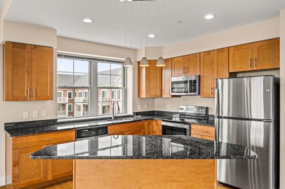 A modern kitchen with wooden cabinets and a dining table with chairs.
