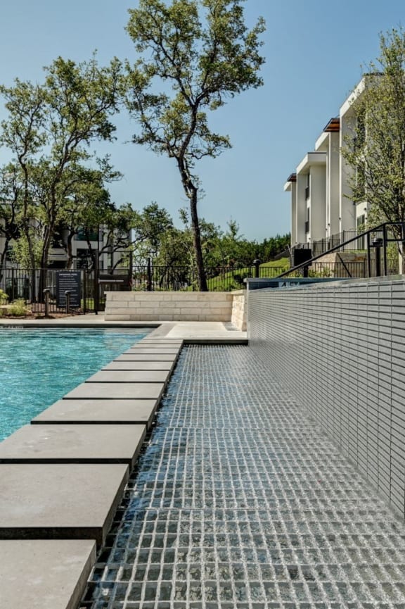 a swimming pool with buildings in the background