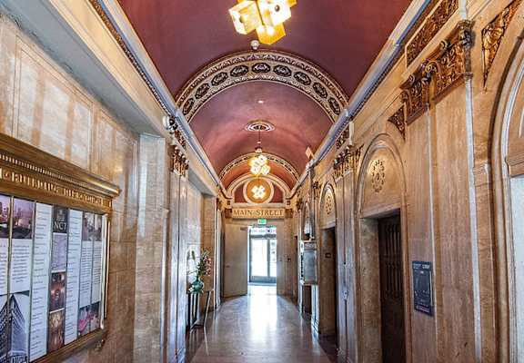 A long hallway with a red ceiling and a sign that says Main Street.