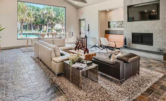 A living room with a large couch and a fireplace.