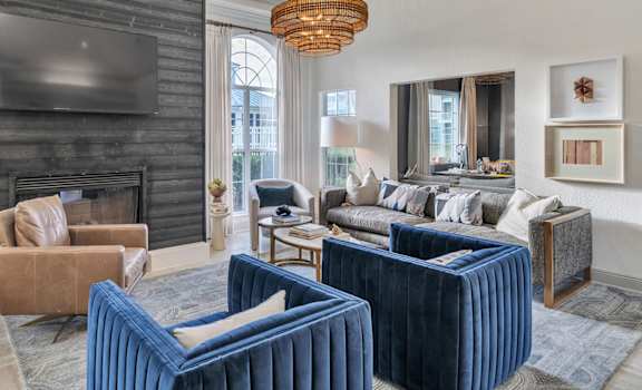 A living room with a fireplace and a television above it.