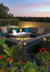 a terrace with couches and a fire pit
