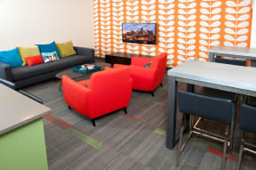Bright Over-sized Chairs in Clubroom at 2800 Girard Apartments