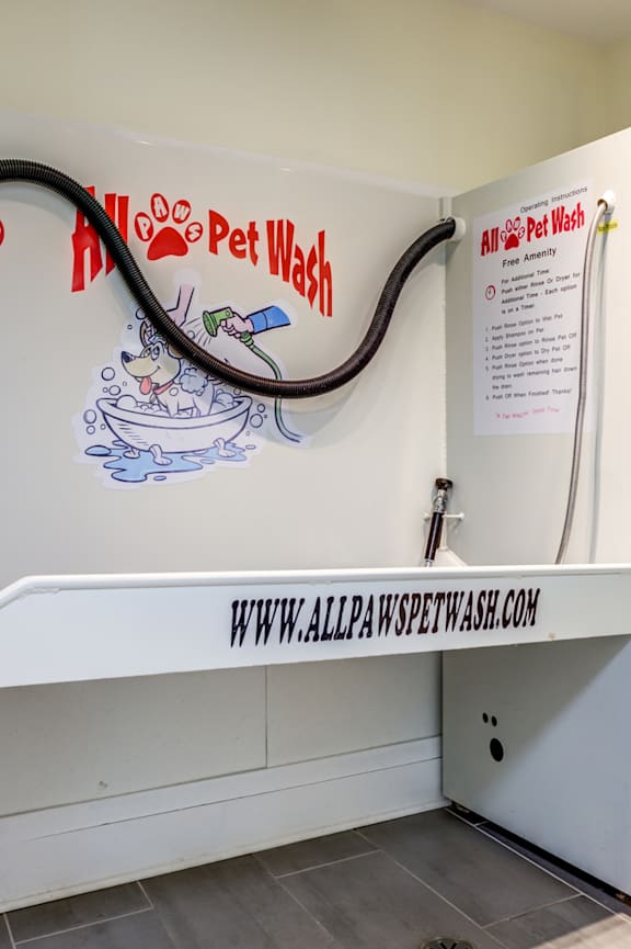 a bench in a room with a hose on the wall