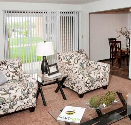 model aprtment living room with dining room in the background