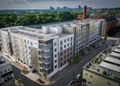 Thumbnail 12 of 35 - an aerial view of a large apartment building with a river and cityscape in the background at East 51 At Rocketts Landing, Richmond, 23231