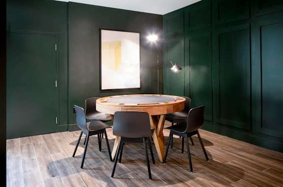 a round table with chairs in a room with green walls at The Irvine, Philadelphia