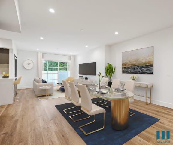 a dining room and living room with white walls and hardwood floors