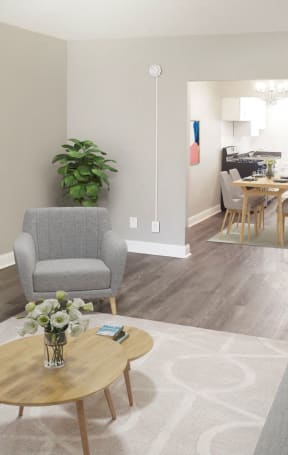 A living room with a grey couch, a wooden coffee table, and a grey armchair. at Park Crest Apartments, Washington, 20007