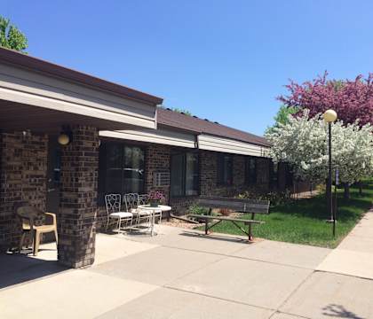 A building with a patio and a bench.