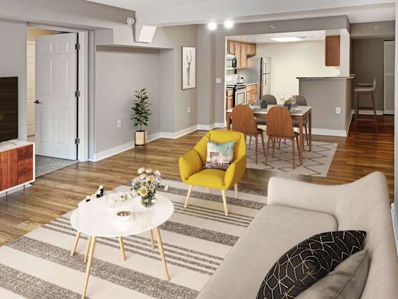 A living room with a yellow chair and a white coffee table.