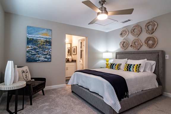a bedroom with a bed and a ceiling fan