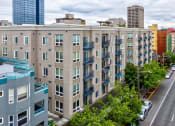Thumbnail 20 of 22 - A street view of a city with apartment buildings.
