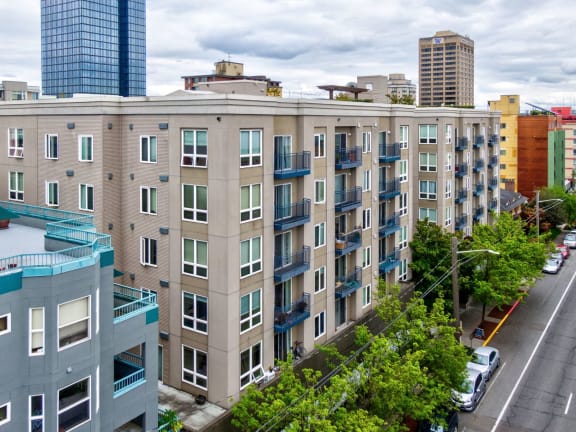 A street view of a city with apartment buildings.
