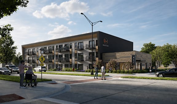 A modern building with a black facade and a yellow sign on the top right corner.