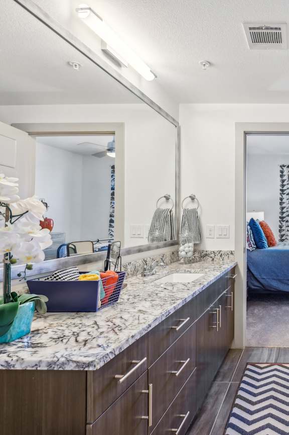 A bathroom with a white tub and a zig zag rug.