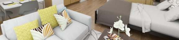 A modern living room with a grey couch and a coffee table.