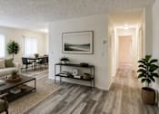 Thumbnail 8 of 8 - A living room with a white couch, a coffee table, and a painting on the wall.