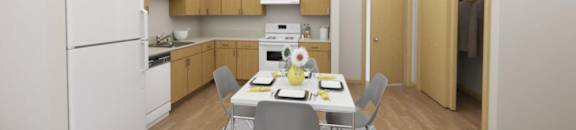 A kitchen with a table and chairs in the middle of the room.