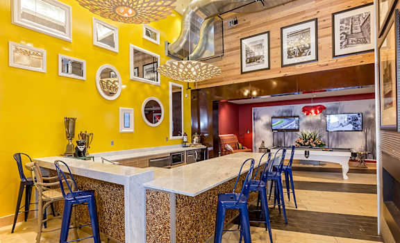A kitchen with a yellow wall and a white counter.