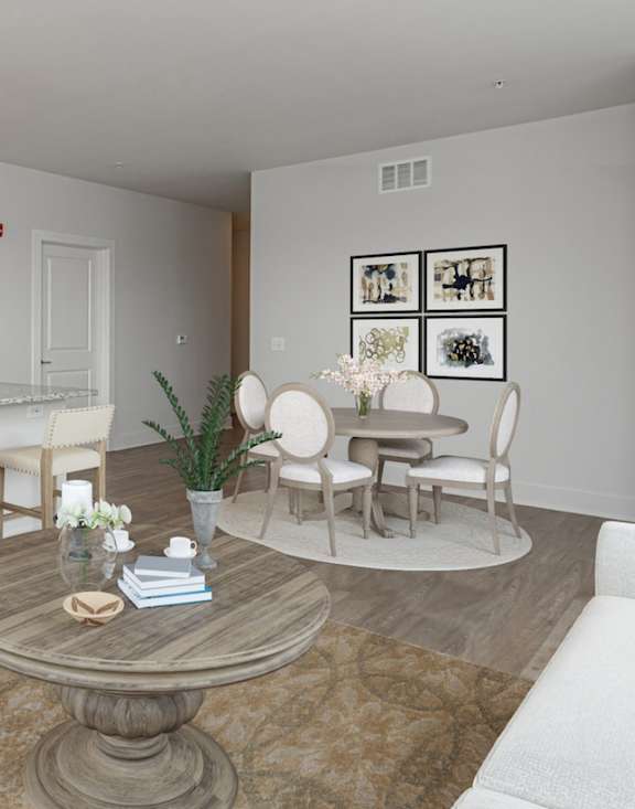 A modern kitchen with a dining table and chairs.