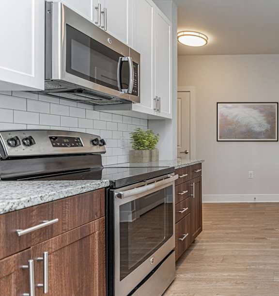 A kitchen with wooden cabinets and granite countertops.