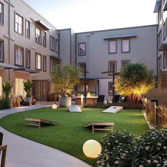 A modern apartment complex with a well-maintained outdoor seating area.